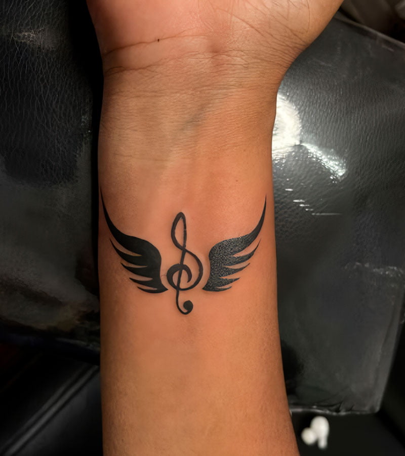 tatuajes de notas musicales con alas 5